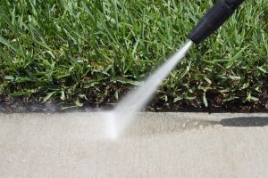 pressure cleaning being done to a sidewalk