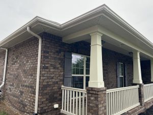Gutters after pressure washing on a brick house