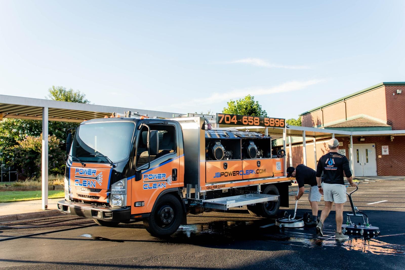 JB Power Clean commercial pressure washing – worker cleaning school grounds