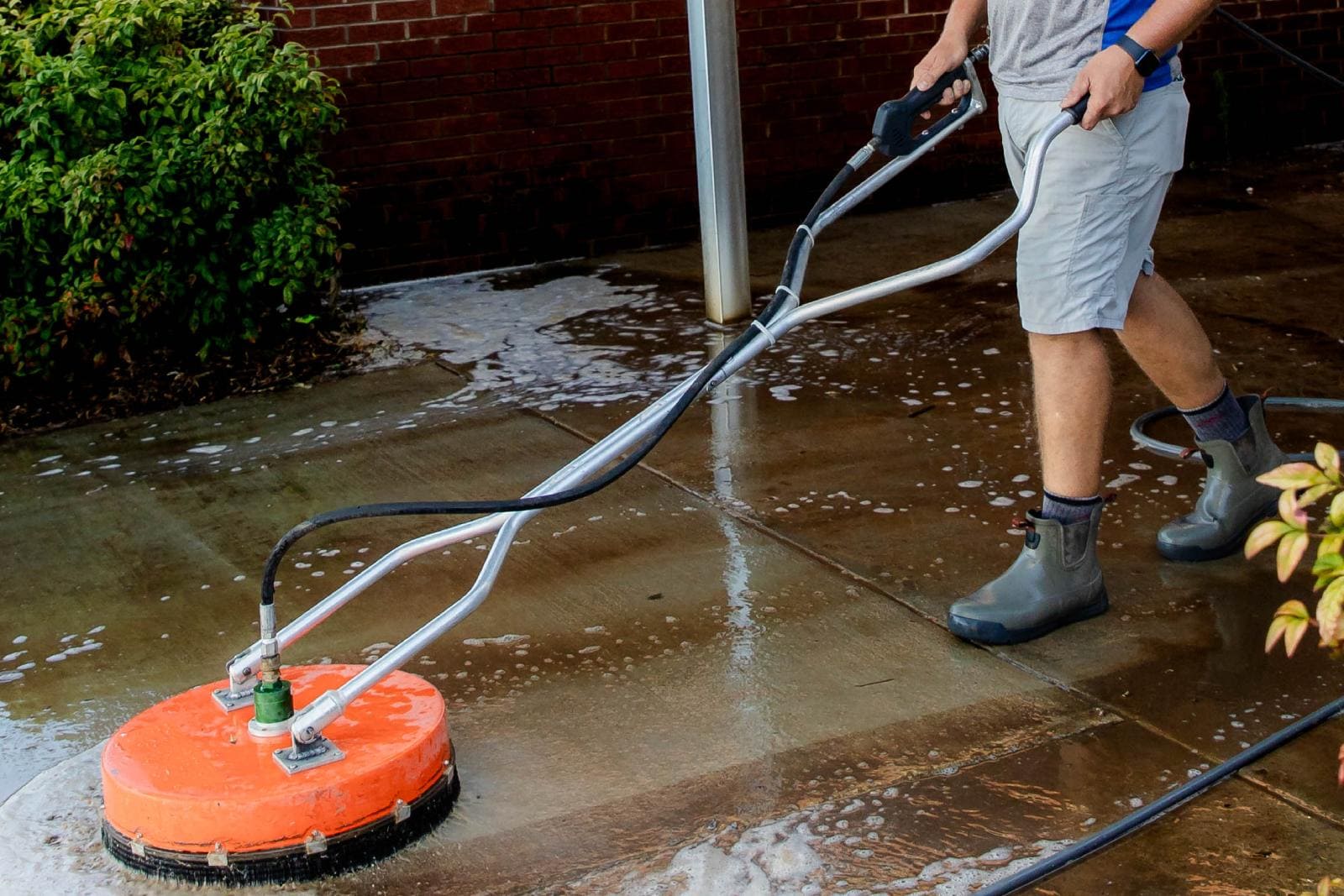 JB Power Clean commercial pressure washing – worker cleaning school grounds