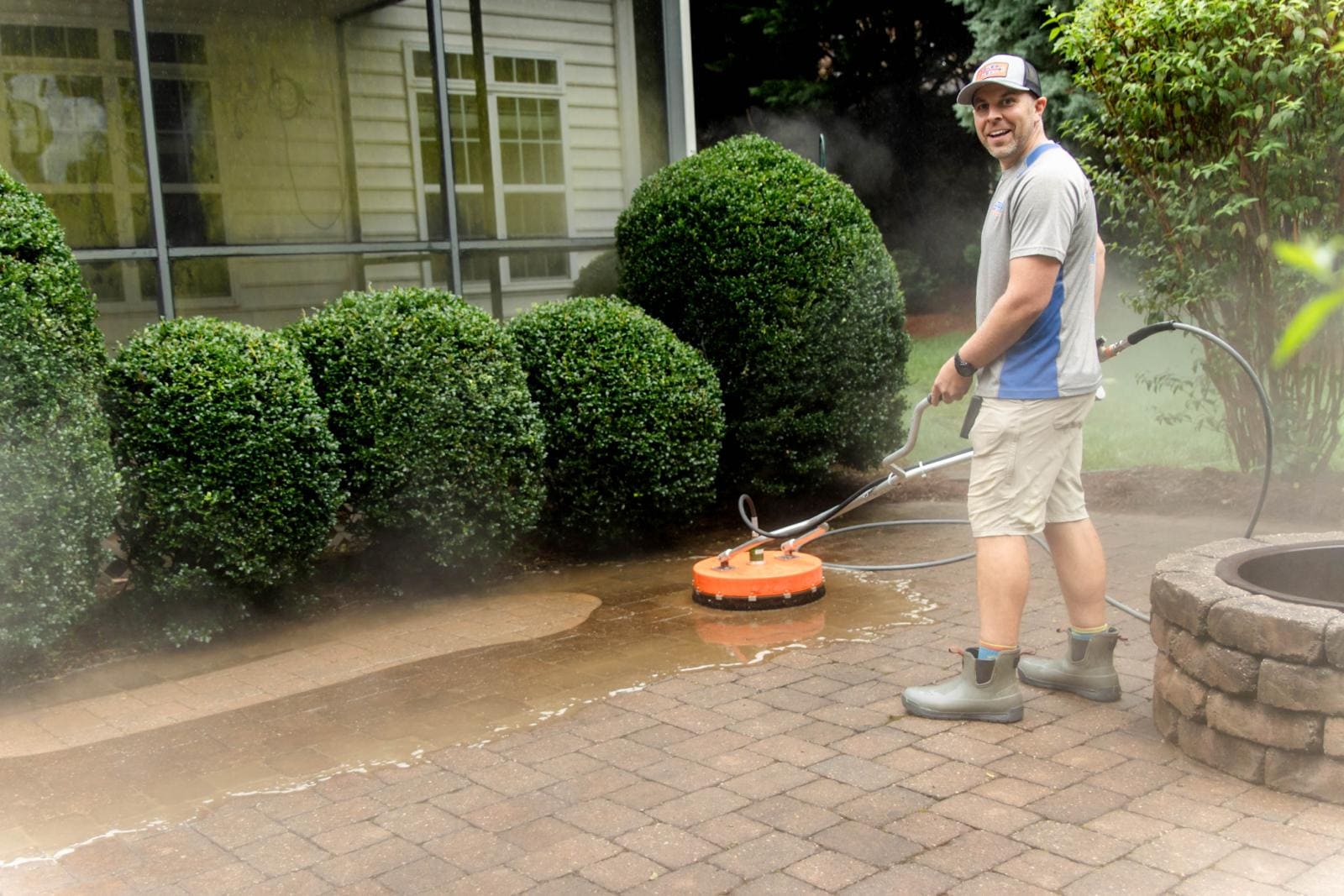 JB Power Clean pressure washing – worker cleaning patio area
