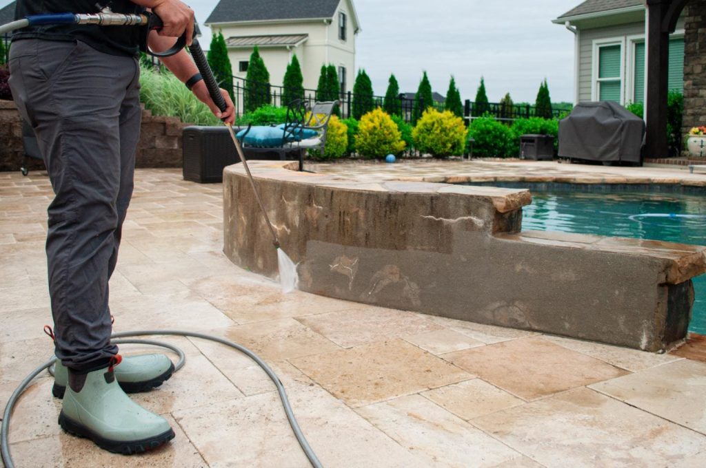 JB Power Clean pressure washing – worker cleaning patio area