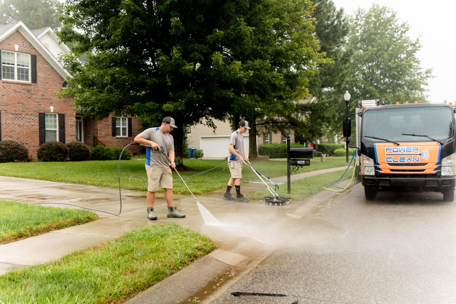 JB Power Clean pressure washing – workers cleaning residential driveway