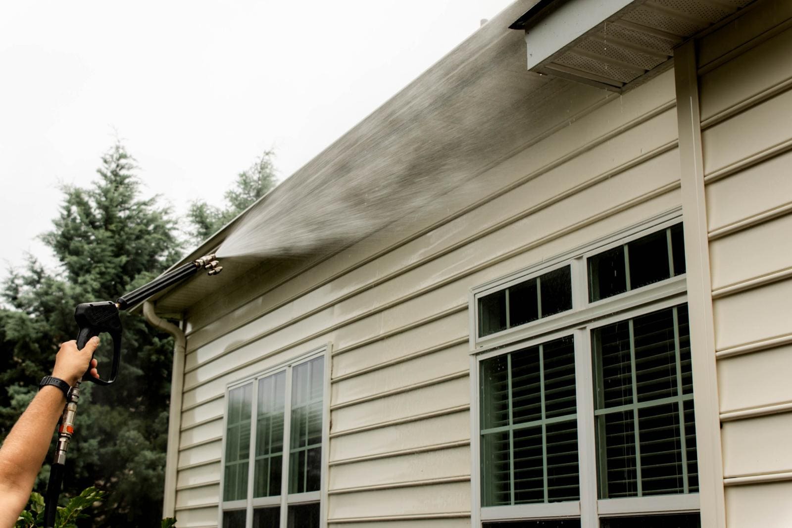 JB Power Clean technician performing pressure house washing