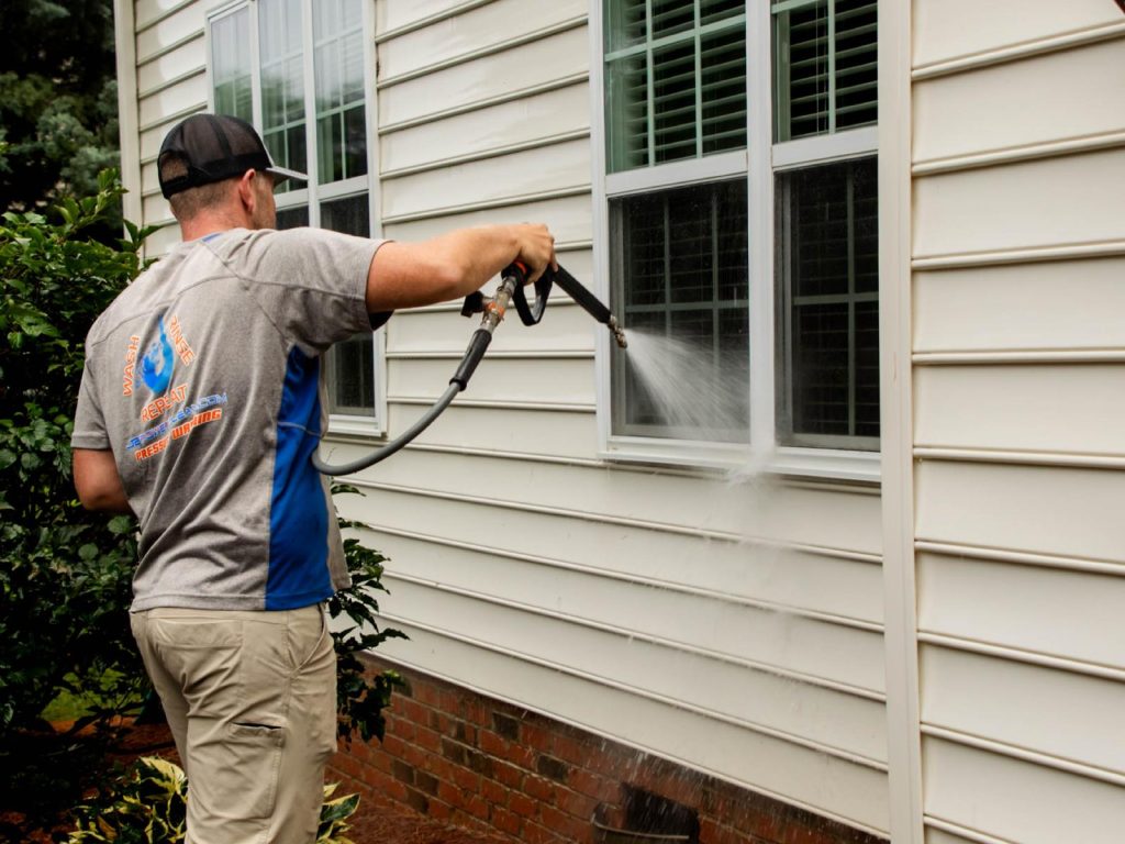 JB Power Clean technician performing pressure house washing