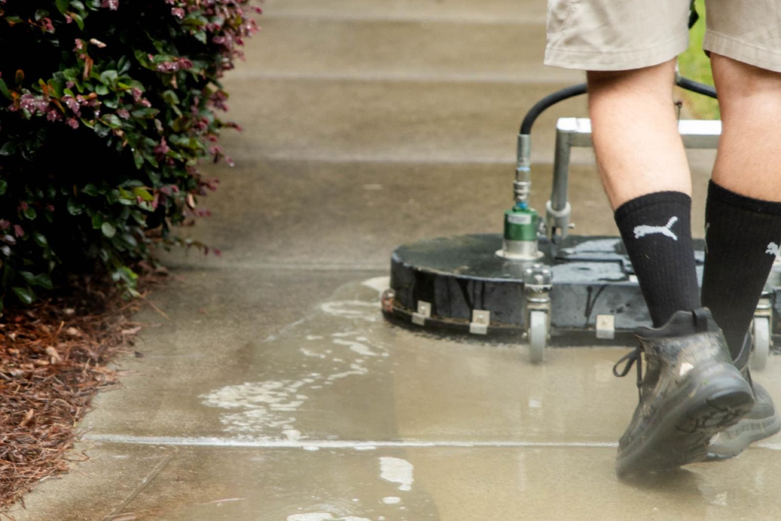 JB Power Clean pressure washing – worker cleaning residential sidewalk