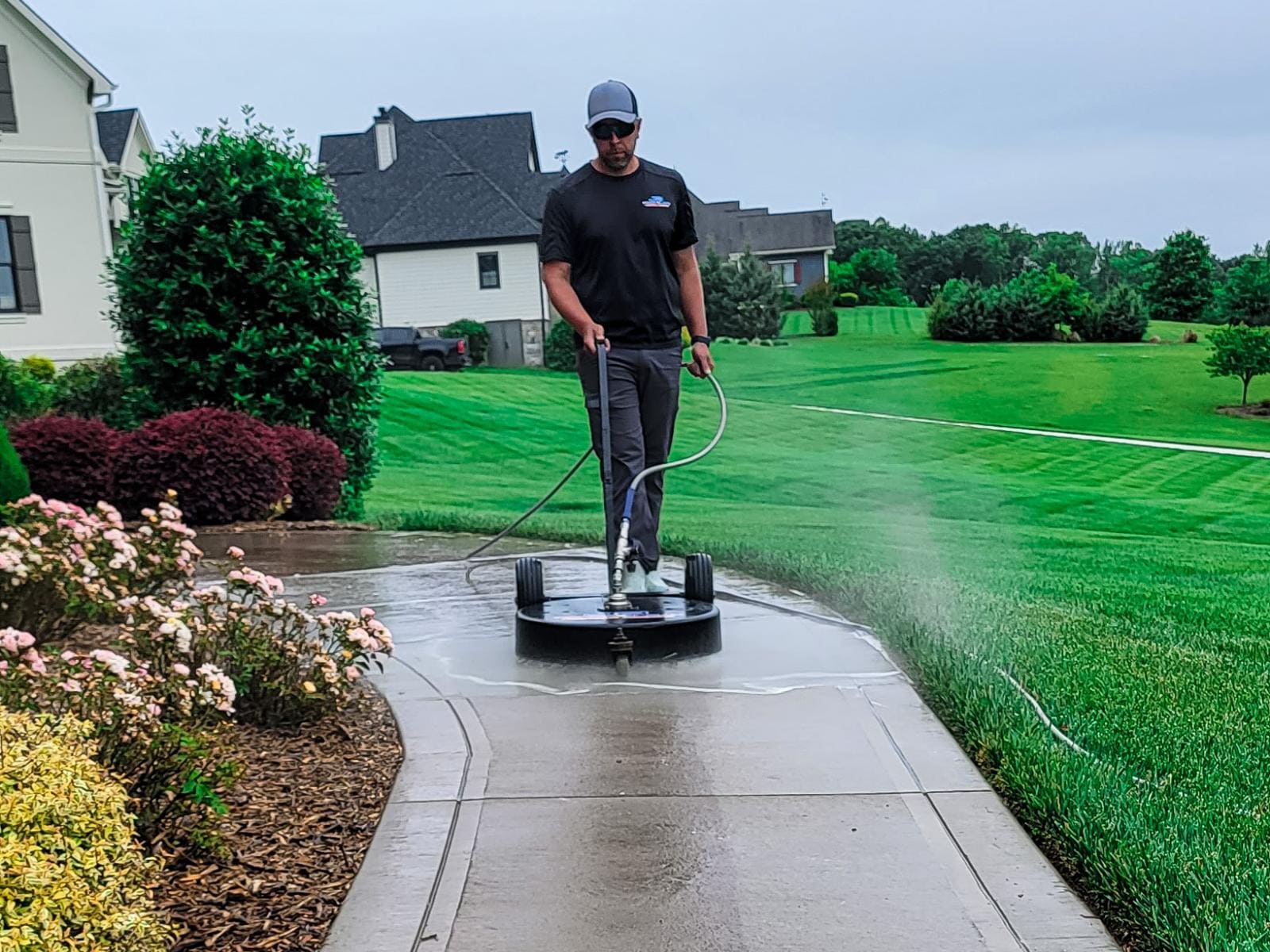 JB Power Clean commercial pressure washing – worker cleaning sidewalk