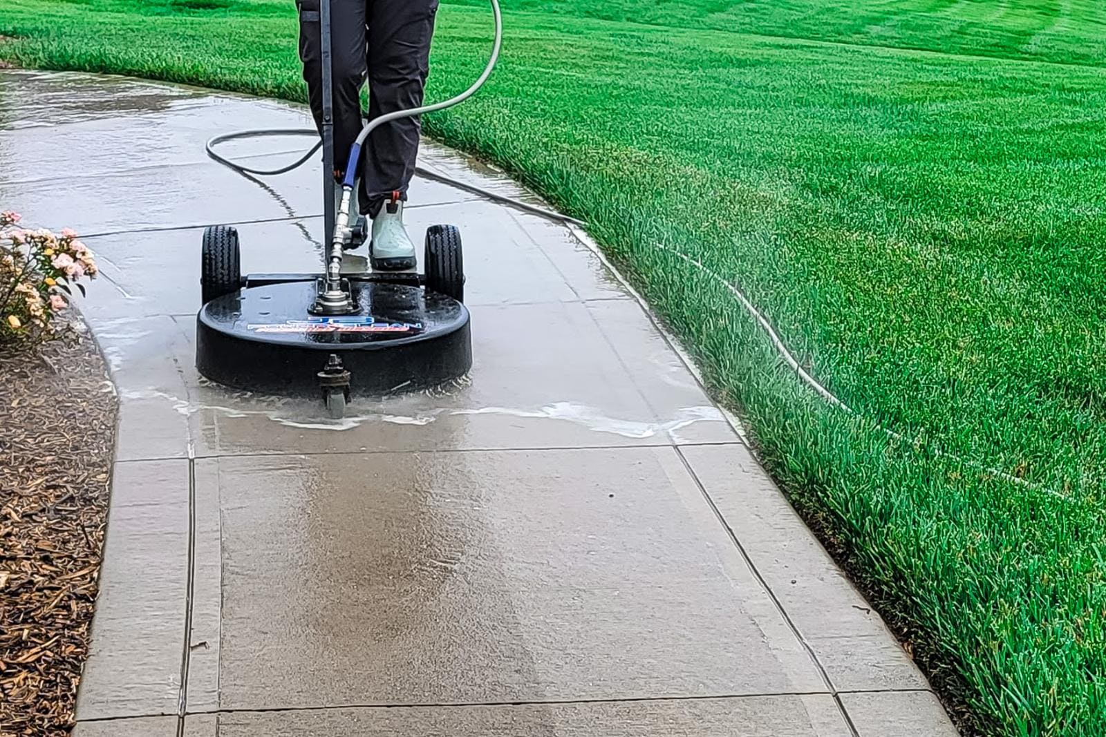 JB Power Clean pressure washing – worker cleaning residential sidewalk