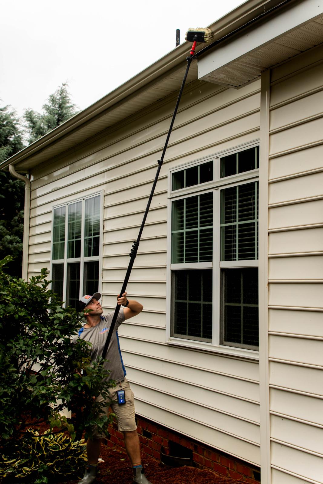 JB Power Clean technician performing professional gutter cleaning