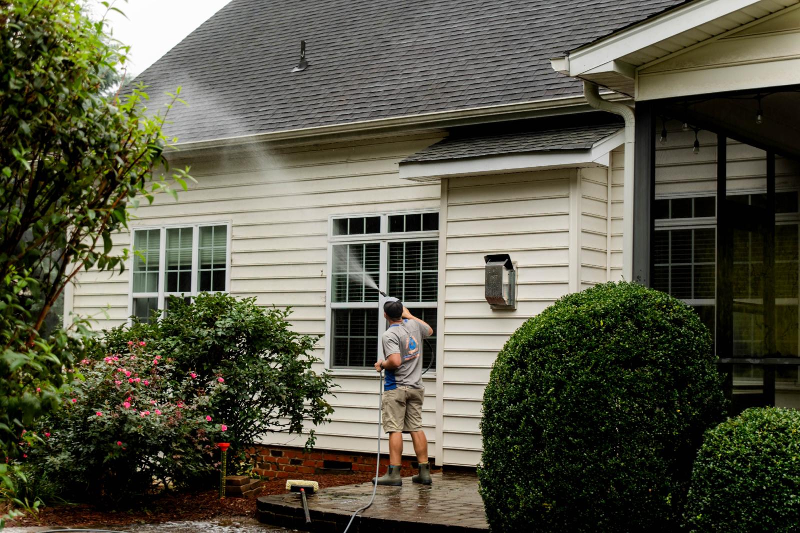 JB Power Clean commercial pressure washing – worker cleaning school grounds
