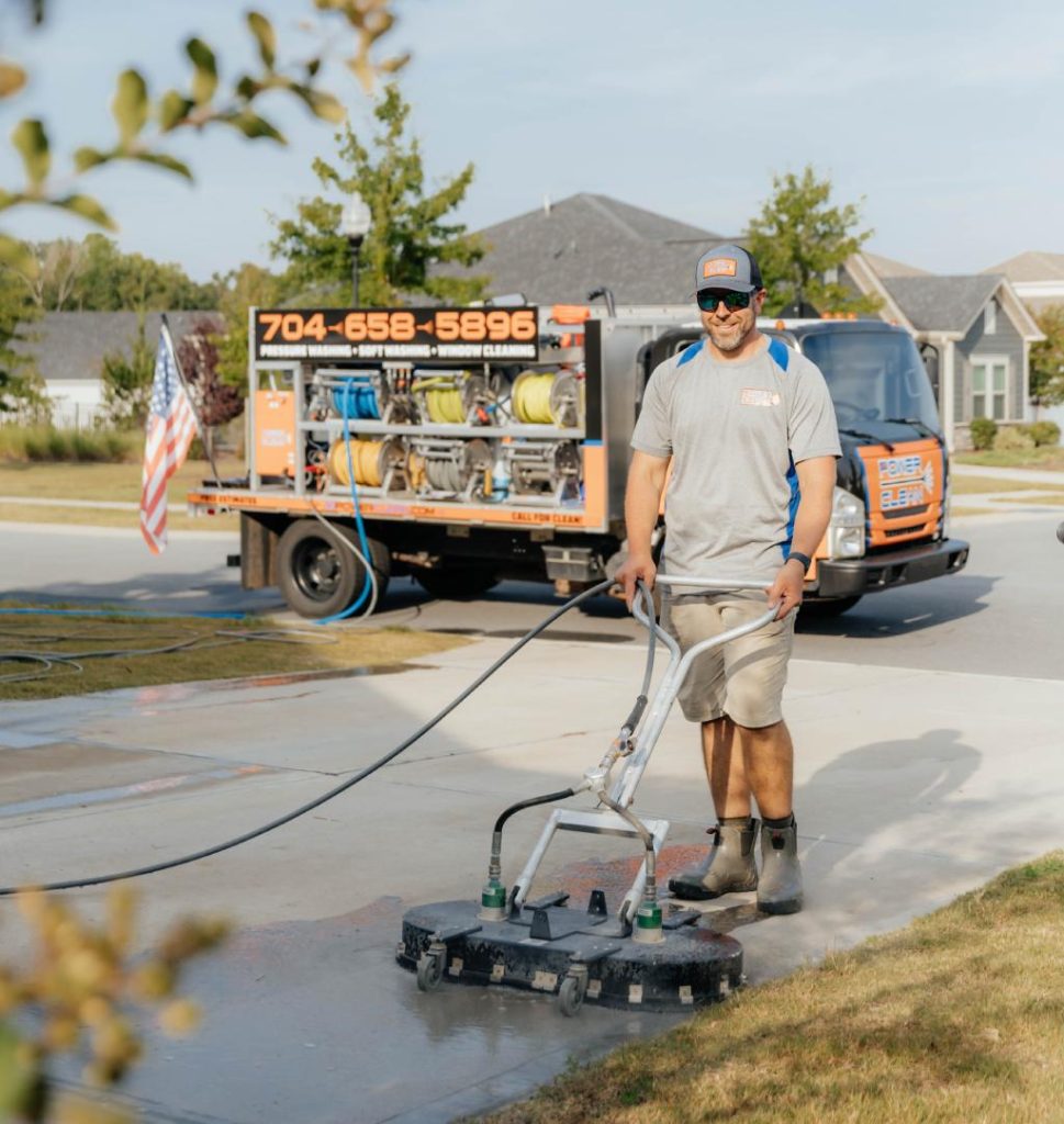 JB Power Clean Pressure Washing – worker cleaning residential driveway