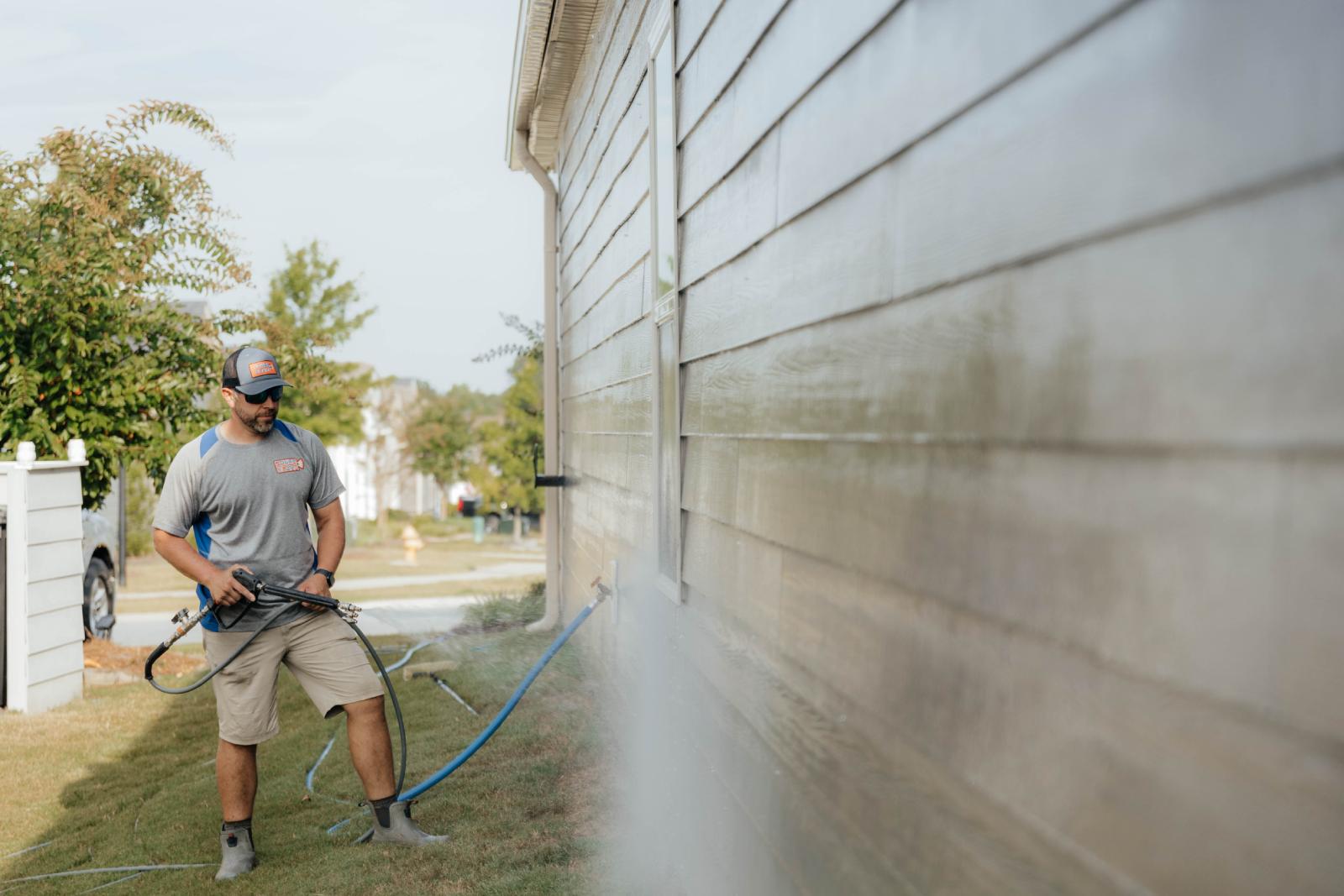 JB Power Clean commercial pressure washing – worker cleaning school grounds