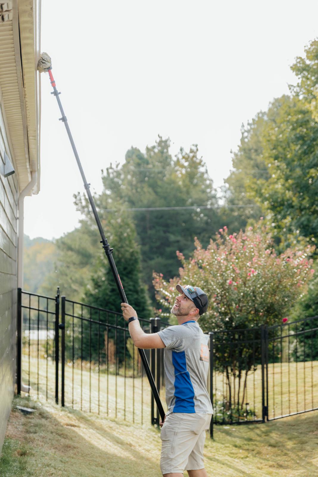 JB Power Clean technician performing professional gutter cleaning