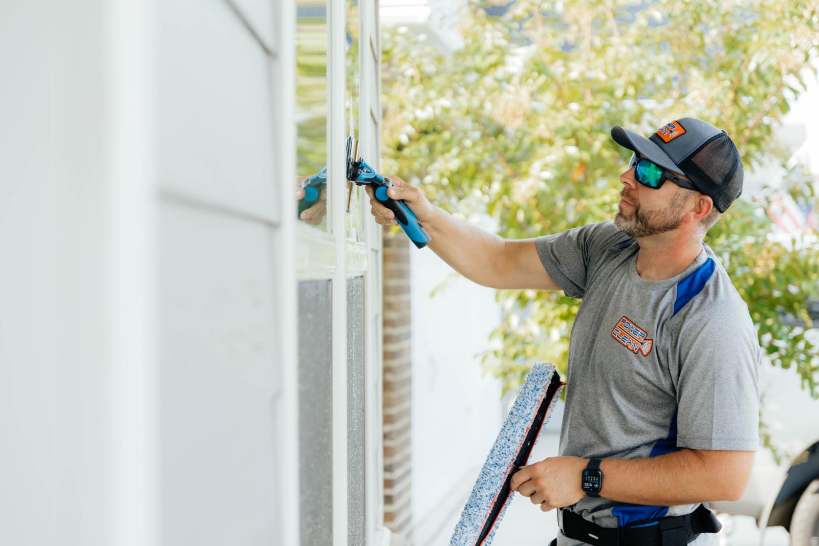 JB Power Clean technician performing professional residential window cleaning