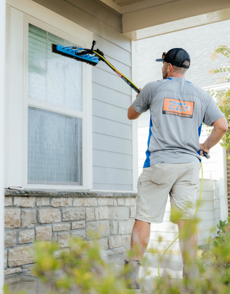 JB Power Clean technician performing professional residential window cleaning