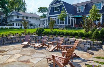 Suburban Backyard Patio with Adirondack Chairs and Lush Garden